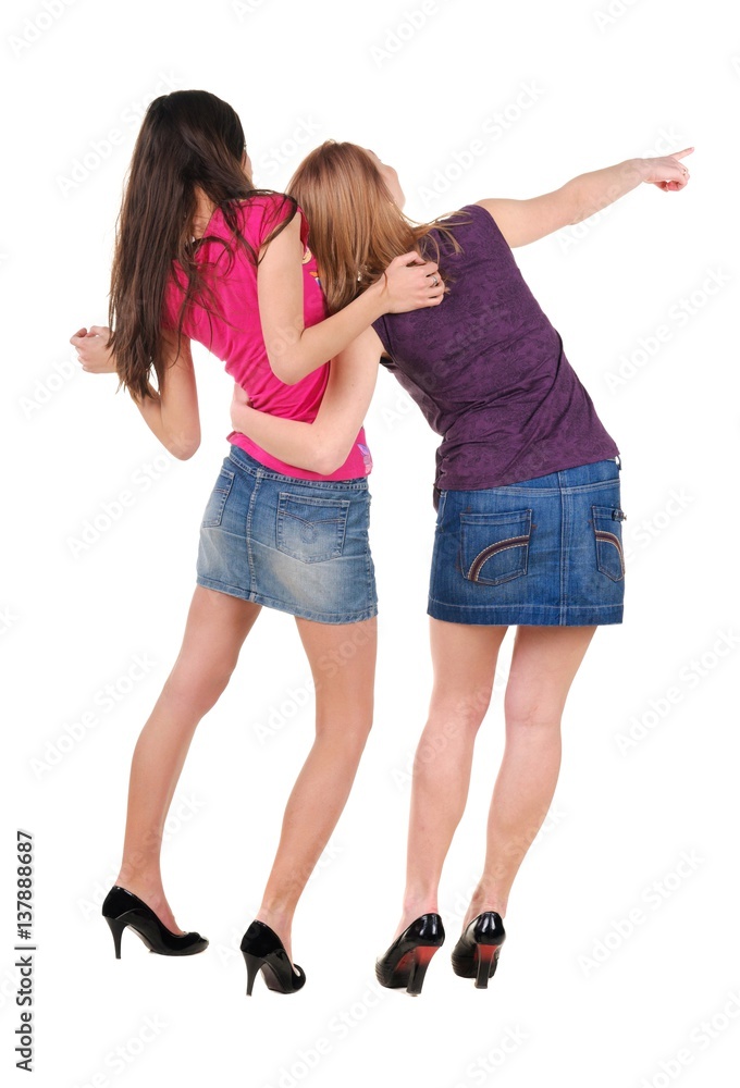 Two young women rear view. Isolated over white. Two young women rear view. Isolated over white.