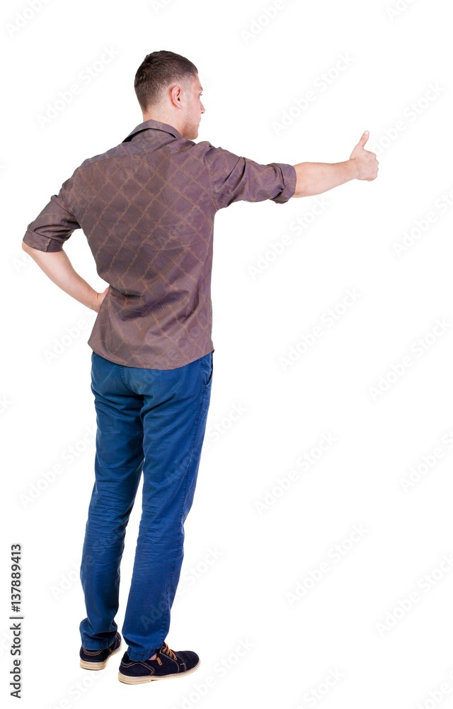 Back view of man in checkered shirt shows thumbs up. Back view of man in checkered shirt shows thumbs up.