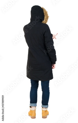 Back view of  pointing young women in parka. © ghoststone