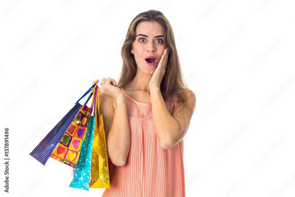 cute girl with great surprise keeps packages in hand cute girl with great surprise keeps packages in hand