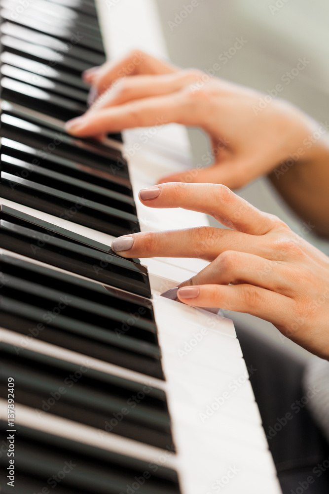 Closeup of hands playing piano. Music and hobby concept Closeup of hands playing piano. Music and hobby concept