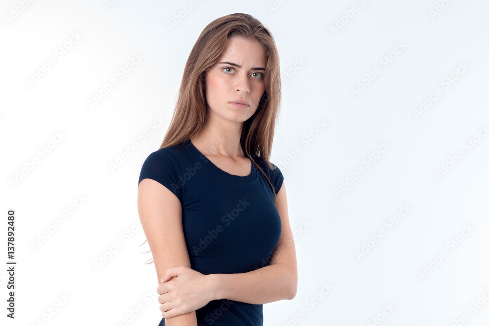 young girl in black t-shirt stands up straight and keeps hand elbow isolated on white background young girl in black t-shirt stands up straight and keeps hand elbow isolated on white background