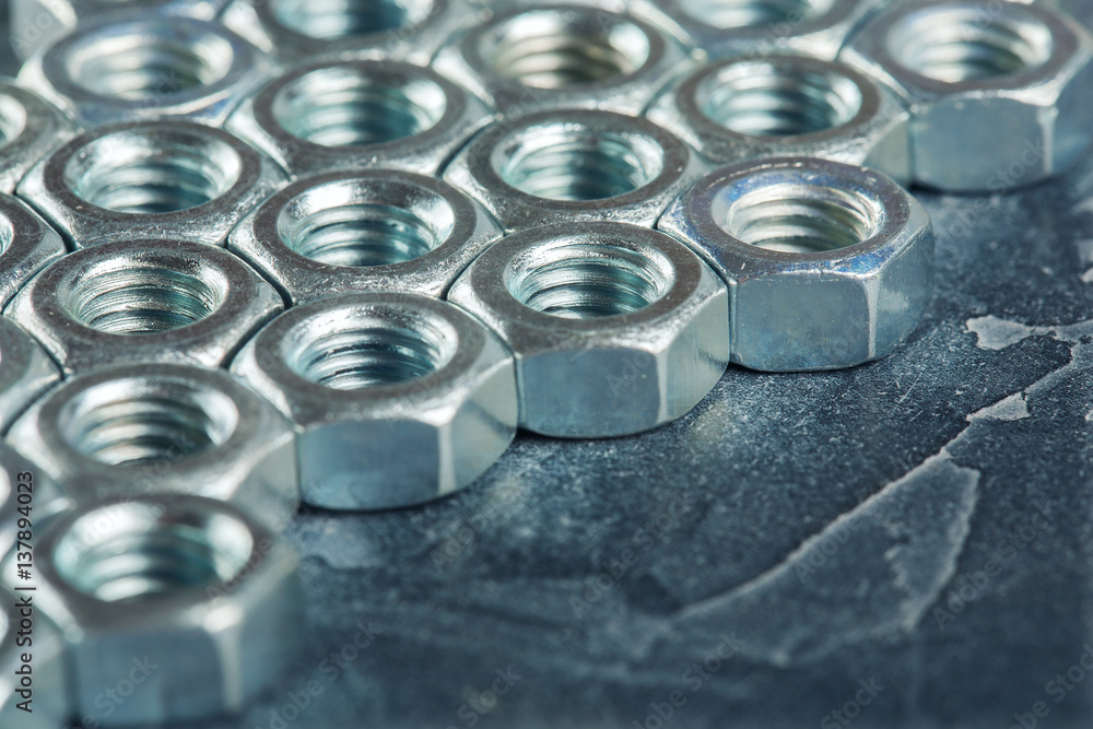 nuts, bolts, screws on a dark concrete background nuts, bolts, screws on a dark concrete background