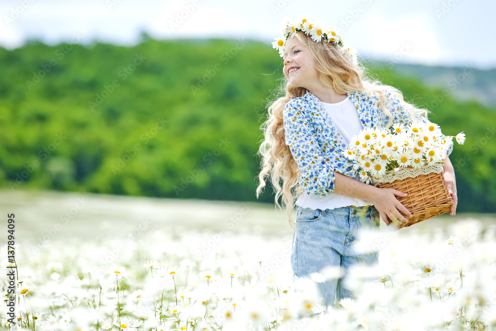 Little girl in a field of flowers Stock Photo | Adobe Stock