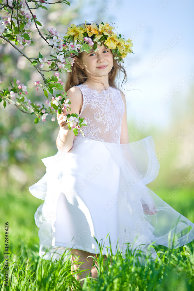 Little girl in garden with flowers Little girl in garden with flowers