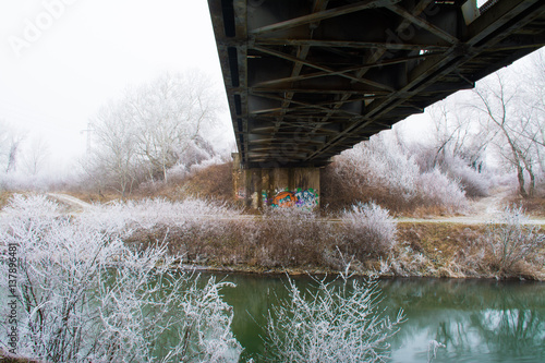 Steel oldbridge in fog weather in winter photo