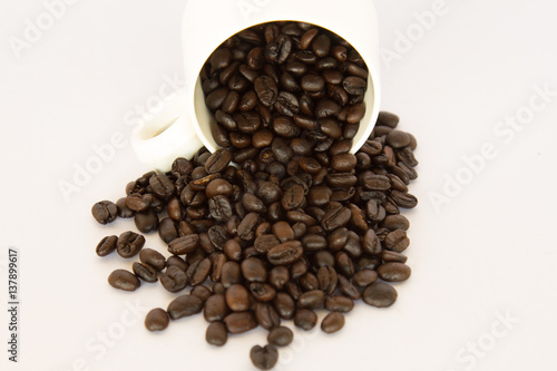 Coffee bean in a White coffee cup on white background.