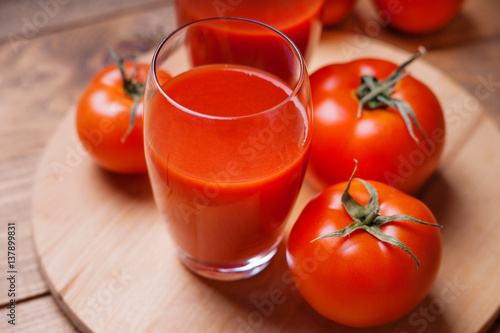 Glass of fresh tomato juice and tomatoes 