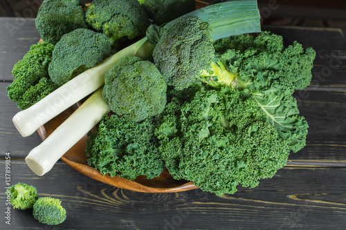 Green winter superfood - Kale green cabbage, broccoli and leeks prei photo