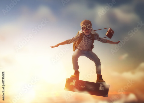 Child flying on a suitcase