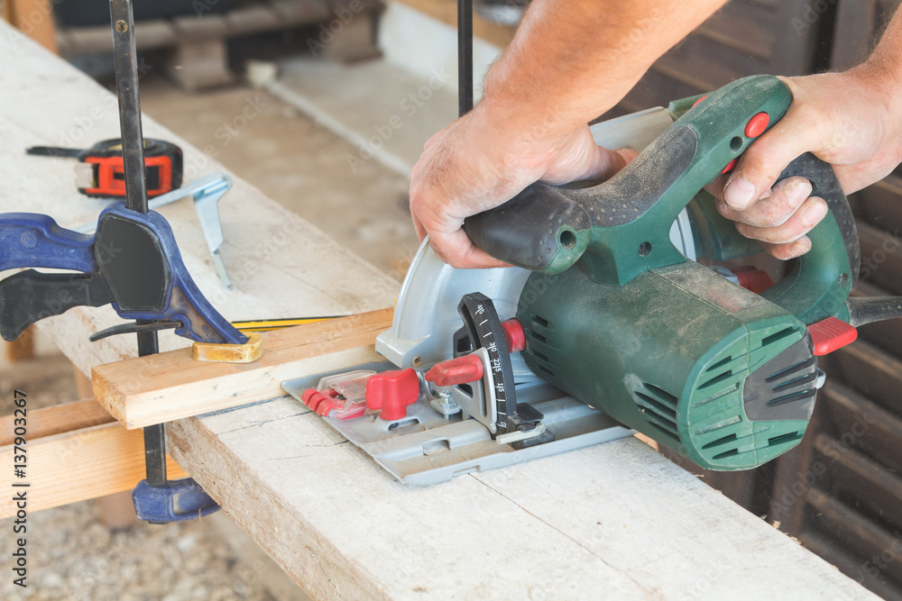 Carpenter working in his small Carpenter working in his small