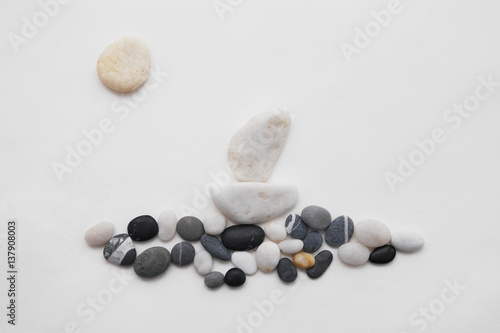 The composition of the stones. The ship sails across the waves. The pebble stones.
