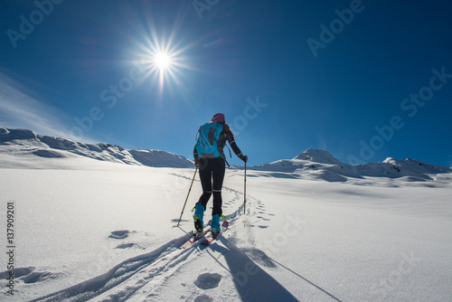 Quadro su tela Uphill girl with seal skins and ski mountaineering