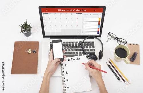 business hand typing on a laptop keyboard with Calender Planner homepage on the computer screen. organization management remind concept.