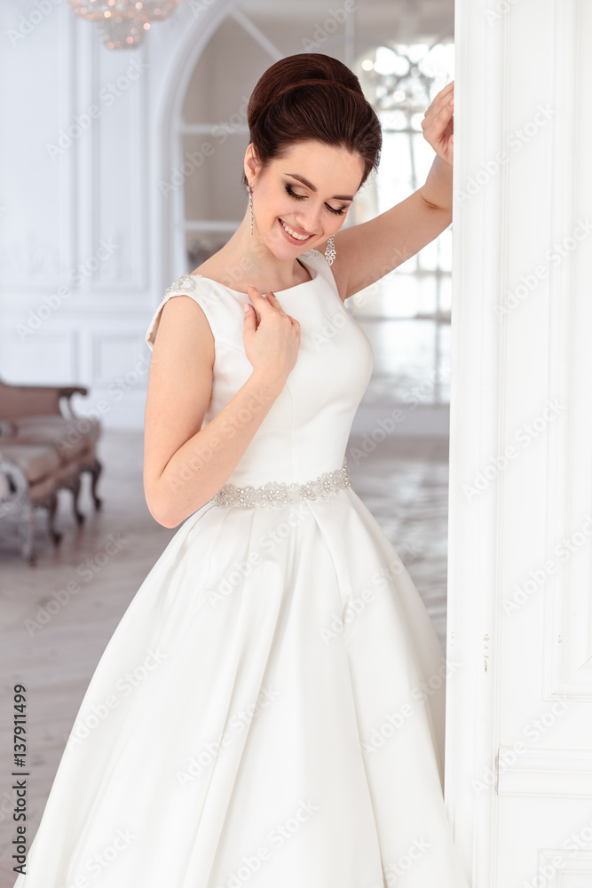 close-up portrait of beautiful brunette bride with elegant hairstyle and makeup wearing long luxury wedding dress close-up portrait of beautiful brunette bride with elegant hairstyle and makeup wearing long luxury wedding dress