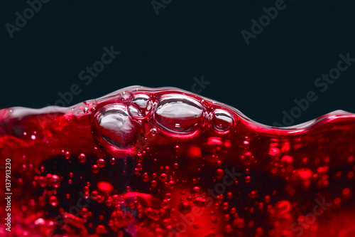 Abstract splashes of red wine on a black background