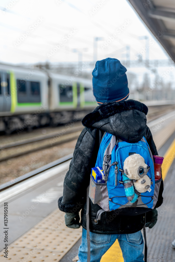 Travel concept of two boys on train station platform