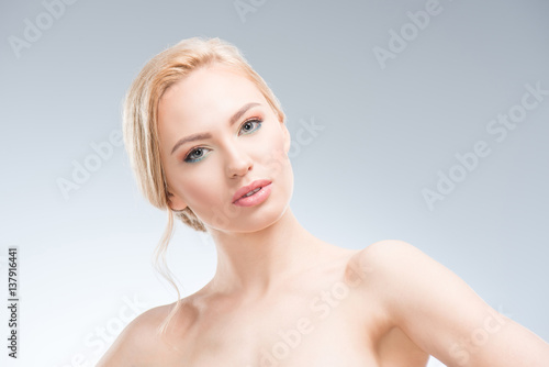 Gorgeous young sensual woman looking at camera  body care concept