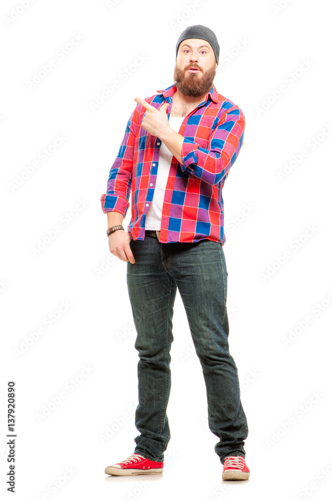 Full length of surprised bearded young man in casual wear pointing copy space Full length of surprised bearded young man in casual wear pointing copy space
