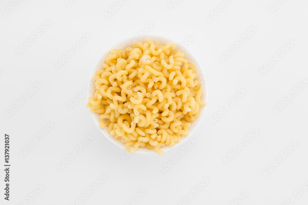 Uncooked macaroni in plate Uncooked macaroni in plate
