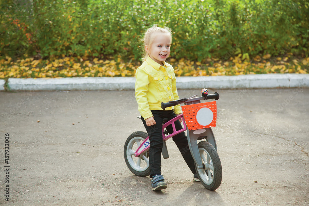 Cute little girl on pushbike. Expression. Emotions. Cute little girl on pushbike. Expression. Emotions.