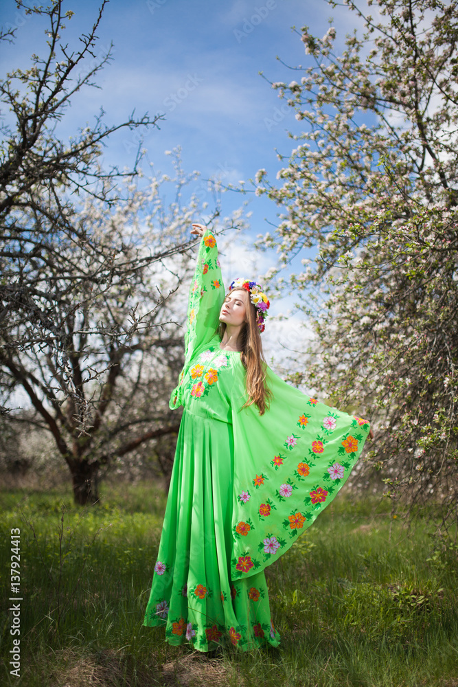 Portrait of beautiful natural woman in nice green dress in the garden of apple Portrait of beautiful natural woman in nice green dress in the garden of apple