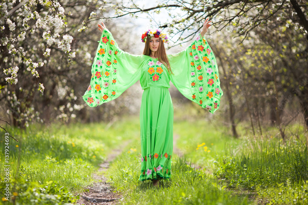 Portrait of beautiful natural woman in nice green dress in the garden of apple Portrait of beautiful natural woman in nice green dress in the garden of apple