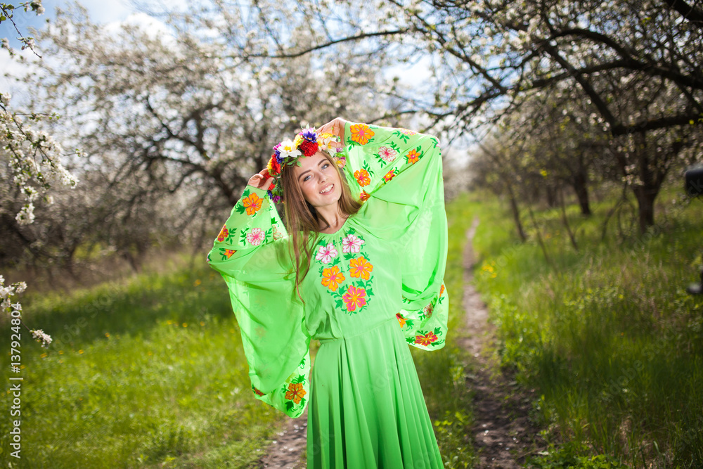 Portrait of beautiful natural smiling woman in nice green dress in the garden of apple Portrait of beautiful natural smiling woman in nice green dress in the garden of apple