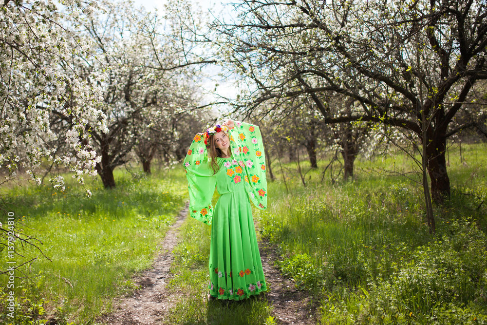 Portrait of beautiful natural smiling woman in nice green dress in the garden of apple Portrait of beautiful natural smiling woman in nice green dress in the garden of apple