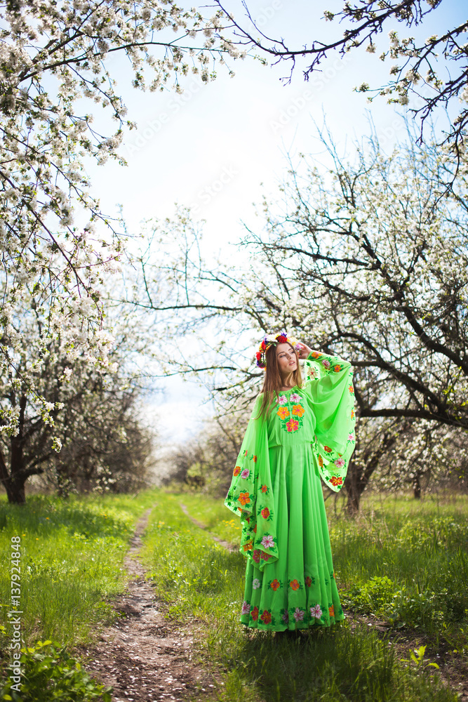 Portrait of beautiful natural woman in nice green dress in the garden of apple Portrait of beautiful natural woman in nice green dress in the garden of apple