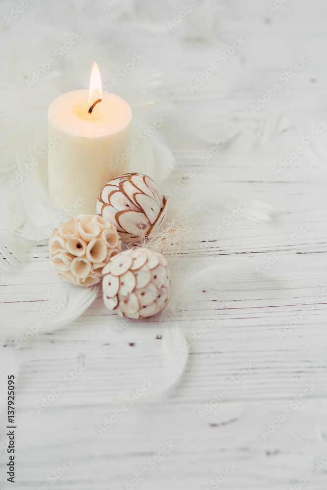 white palm candle with natural decoration for spa on white wooden table white palm candle with natural decoration for spa on white wooden table