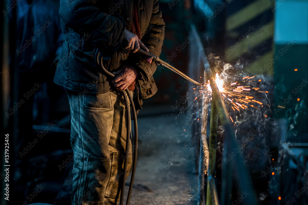 a welder working at the factory a welder working at the factory