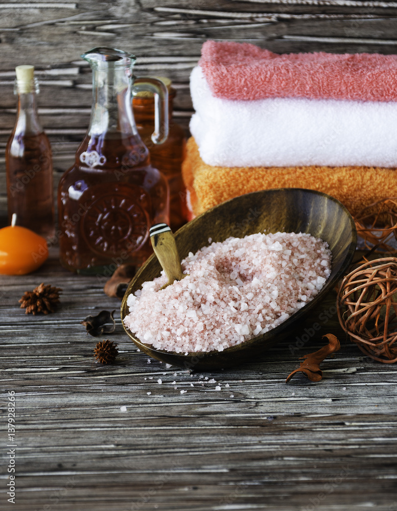 Set for spa with towels, salt and aromatic oils, selective focus Set for spa with towels, salt and aromatic oils, selective focus