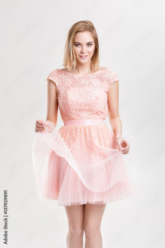 beautiful blond woman in a pink cocktail dress dancing and havin beautiful blond woman in a pink cocktail dress dancing and havin