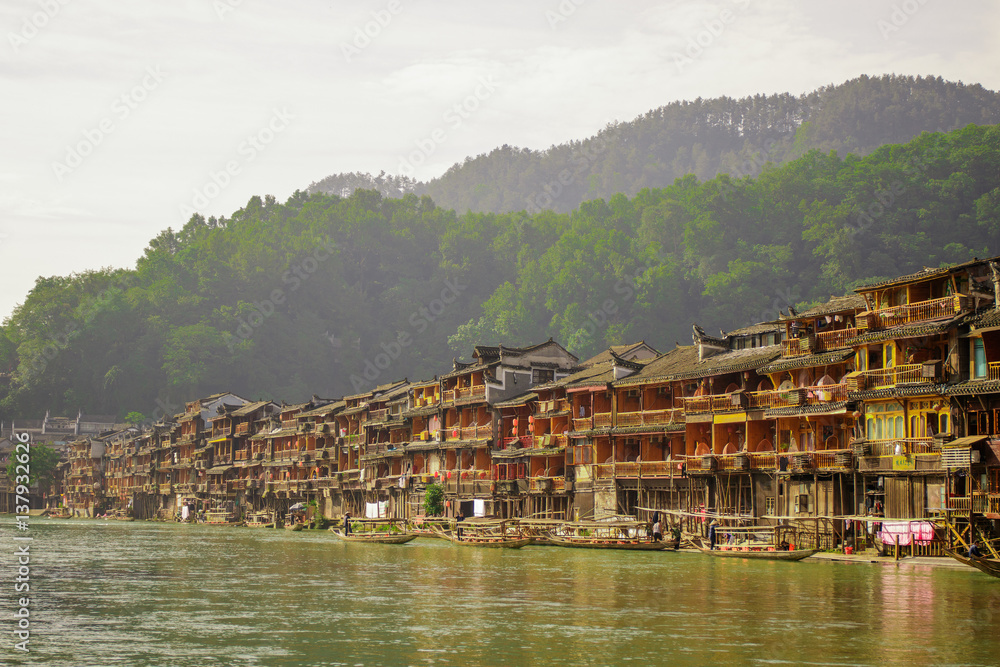 Photo of Ancient City Fenix in China. Historic Asian Scenery with Water Canals, Wooden Houses, Gondola Boats