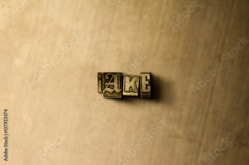 Fényképezés JAKE - close-up of grungy vintage typeset word on metal backdrop