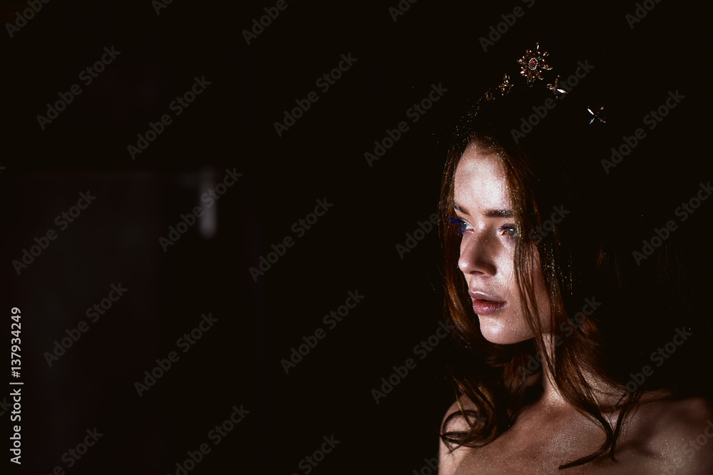 Studio portrait of a beautiful girl with long hair. Glitter on your face. Beautiful eyes. Dark background. Mysterious, mystical, Studio portrait of a beautiful girl with long hair. Glitter on your face. Beautiful eyes. Dark background. Mysterious, mystical,
