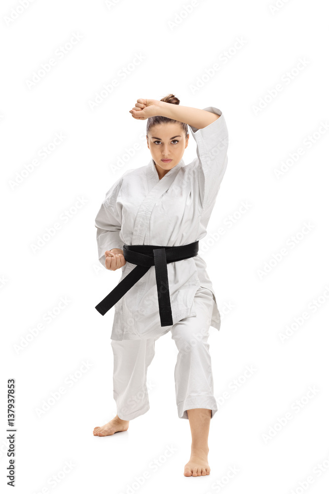 Girl wearing a kimono doing a karate kata Girl wearing a kimono doing a karate kata