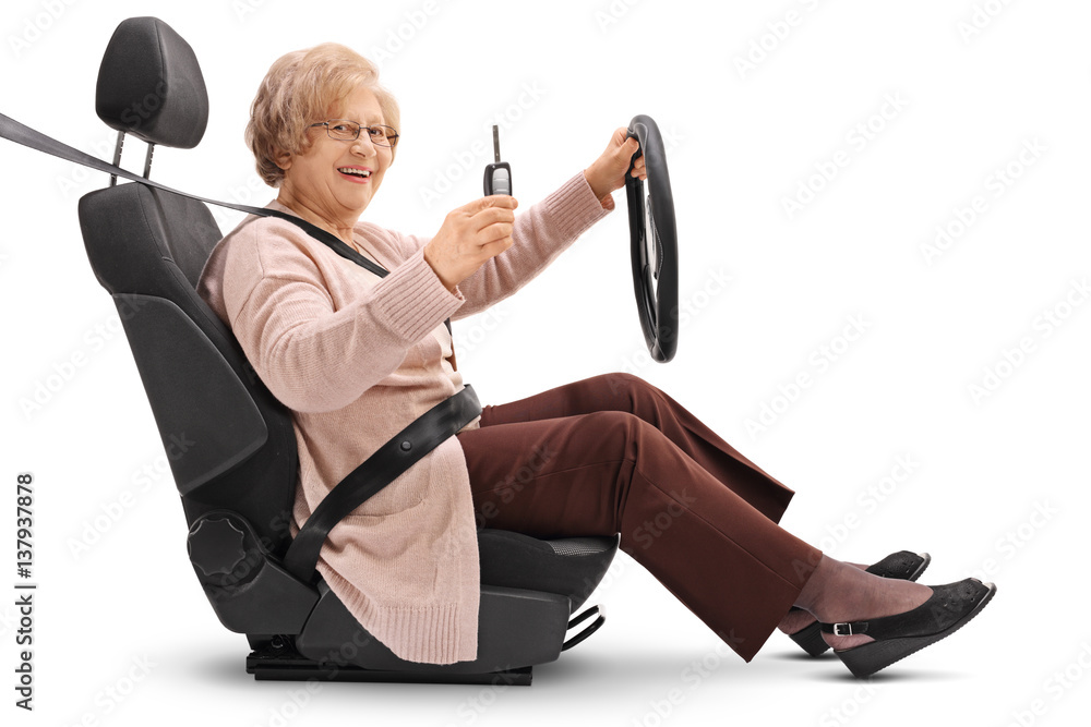 Elderly woman holding car key and sitting in car seat Elderly woman holding car key and sitting in car seat