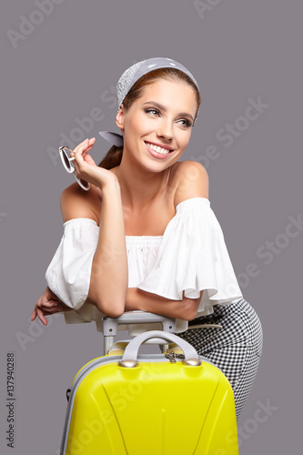 Glamour woman with yellow suitcase, travel concept