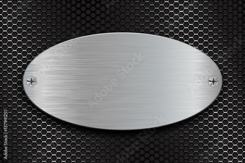 Metal brushed oval plate on perforated steel background