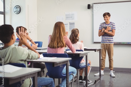 Schoolboy giving presentation in classroom