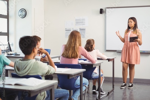 Schoolgirl giving presentation in classroom