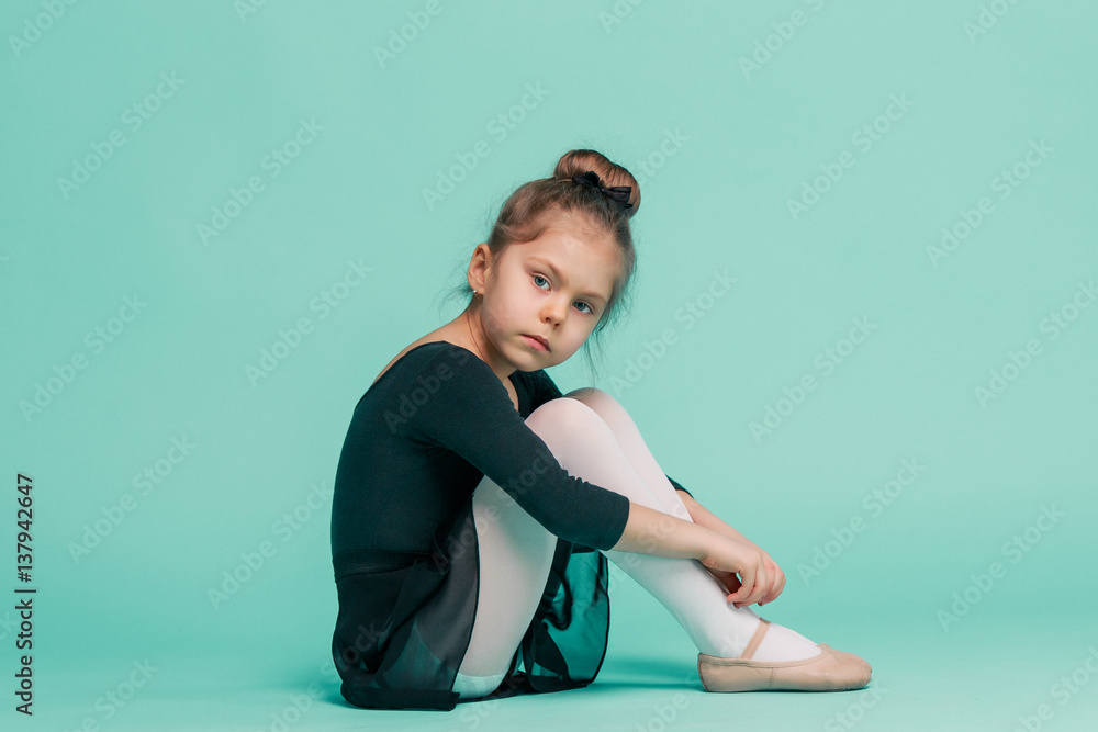 The little balerina dancer on blue background The little balerina dancer on blue background