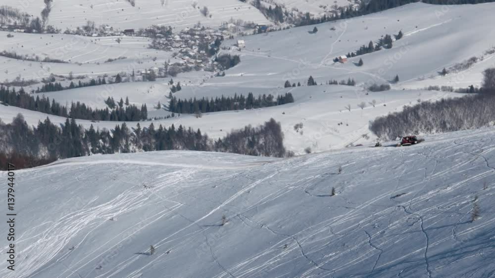 Snowcat With Skiers on the Back Riding on a Snow Covered Mountain Hill at a Winter Sunny Day Snowcat With Skiers on the Back Riding on a Snow Covered Mountain Hill at a Winter Sunny Day