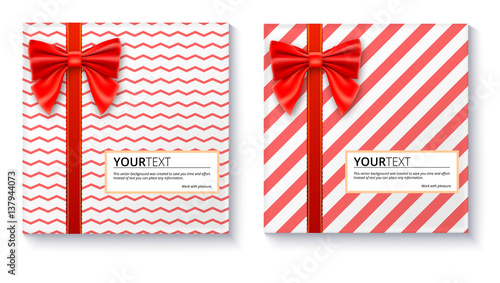 Gift boxes with big red bow and ribbon, isolated on white background. Top view on gift packaged in a paper with pattern and copy-space place for your text