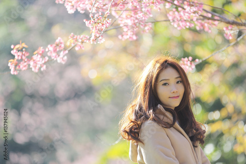 beautiful young woman with blooming cherry blossoms sakura flowers