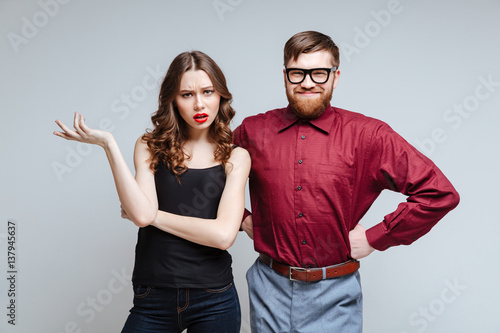 Surprised woman with smiling male nerd photo