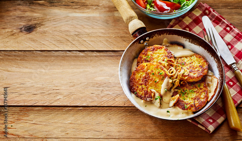 Crisp Potato Pancakes in Pan with Cream Sauce