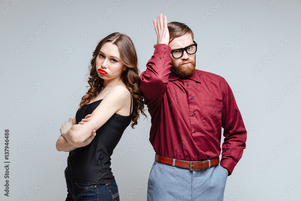 Displeased woman with male nerd Displeased woman with male nerd